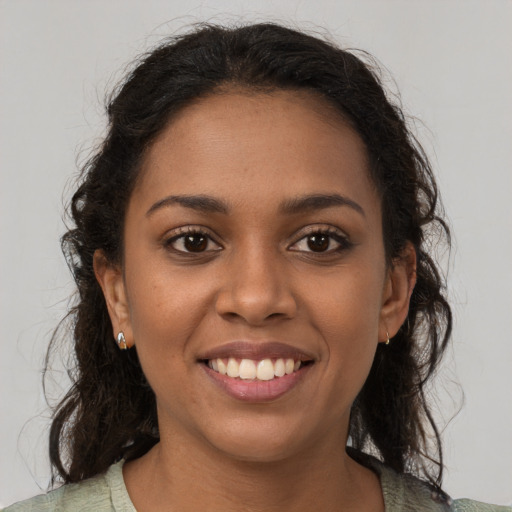 Joyful black young-adult female with medium  brown hair and brown eyes