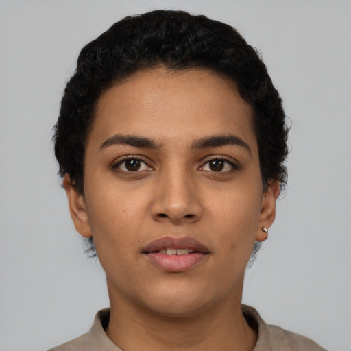 Joyful latino young-adult female with short  black hair and brown eyes