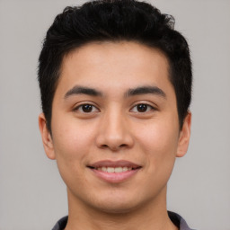 Joyful asian young-adult male with short  black hair and brown eyes