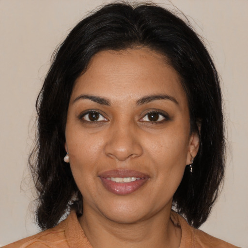 Joyful black young-adult female with medium  brown hair and brown eyes