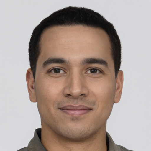 Joyful latino young-adult male with short  black hair and brown eyes