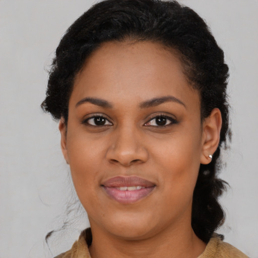 Joyful black young-adult female with medium  brown hair and brown eyes