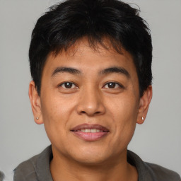 Joyful asian young-adult male with short  brown hair and brown eyes