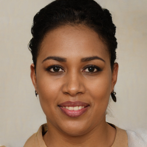 Joyful black young-adult female with short  brown hair and brown eyes
