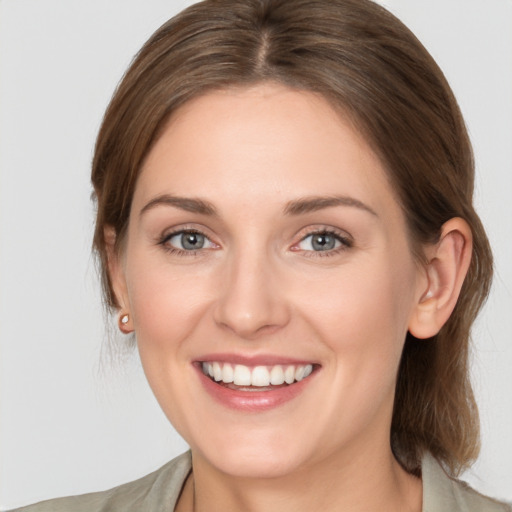 Joyful white young-adult female with medium  brown hair and blue eyes