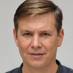 Joyful white adult male with short  brown hair and grey eyes