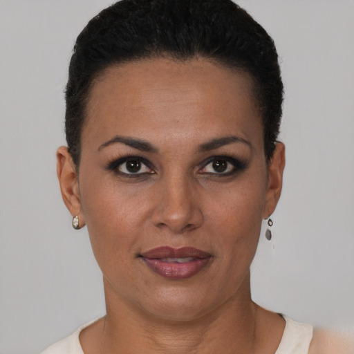 Joyful black young-adult female with short  black hair and brown eyes