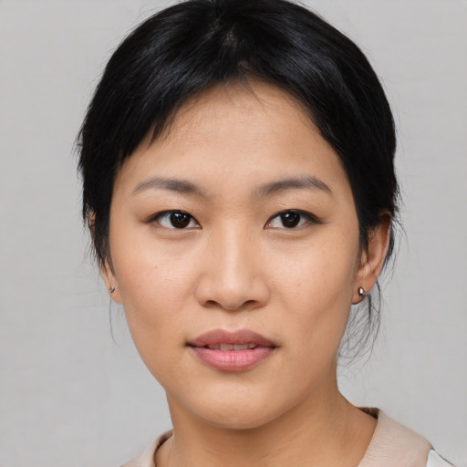 Joyful asian young-adult female with medium  black hair and brown eyes