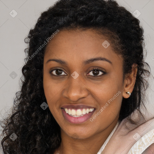 Joyful black young-adult female with long  brown hair and brown eyes