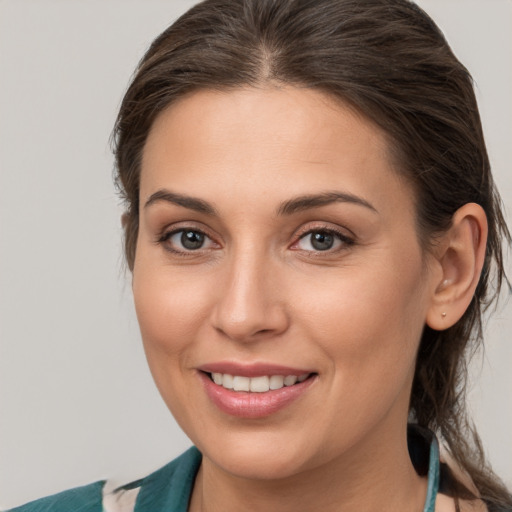 Joyful white young-adult female with medium  brown hair and brown eyes