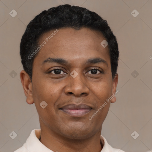 Joyful black young-adult male with short  black hair and brown eyes