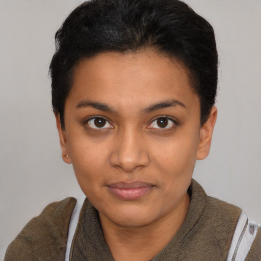 Joyful black young-adult female with short  black hair and brown eyes