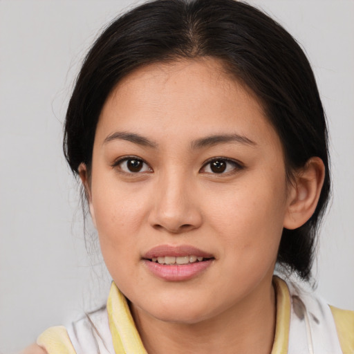 Joyful asian young-adult female with medium  brown hair and brown eyes