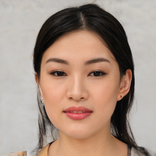 Joyful asian young-adult female with medium  black hair and brown eyes