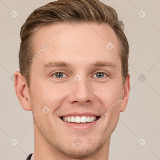 Joyful white young-adult male with short  brown hair and grey eyes