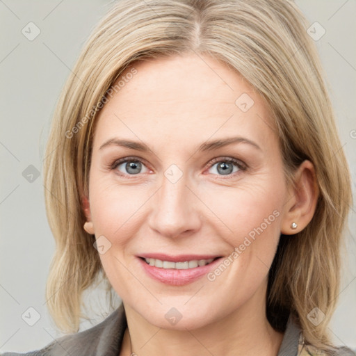 Joyful white young-adult female with medium  brown hair and blue eyes