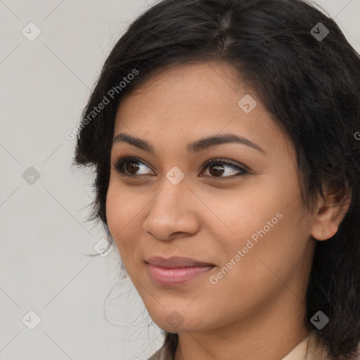 Joyful latino young-adult female with long  brown hair and brown eyes