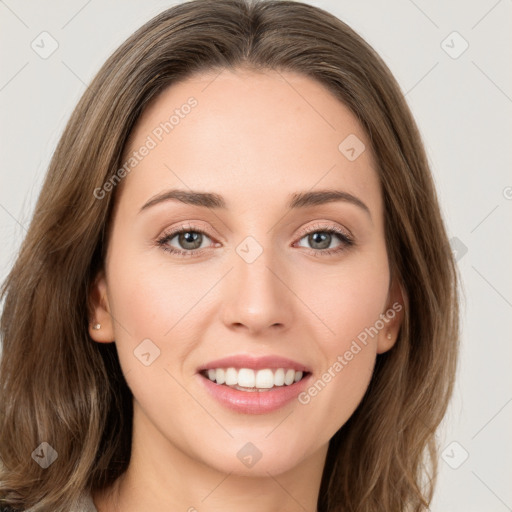 Joyful white young-adult female with long  brown hair and green eyes