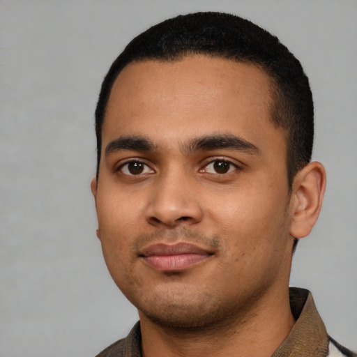 Joyful latino young-adult male with short  black hair and brown eyes