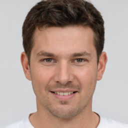 Joyful white young-adult male with short  brown hair and brown eyes