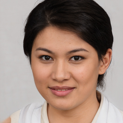Joyful latino young-adult female with medium  brown hair and brown eyes