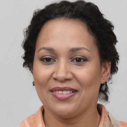 Joyful latino adult female with short  brown hair and brown eyes