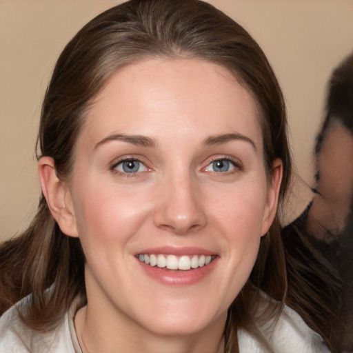 Joyful white young-adult female with medium  brown hair and grey eyes