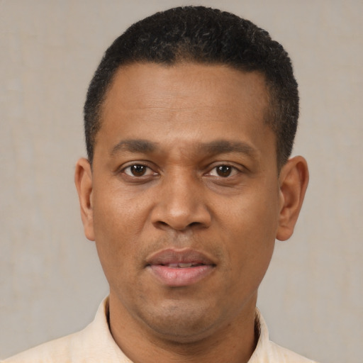 Joyful latino adult male with short  black hair and brown eyes