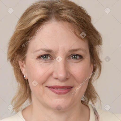 Joyful white adult female with medium  brown hair and blue eyes