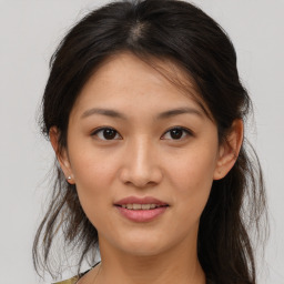 Joyful asian young-adult female with medium  brown hair and brown eyes