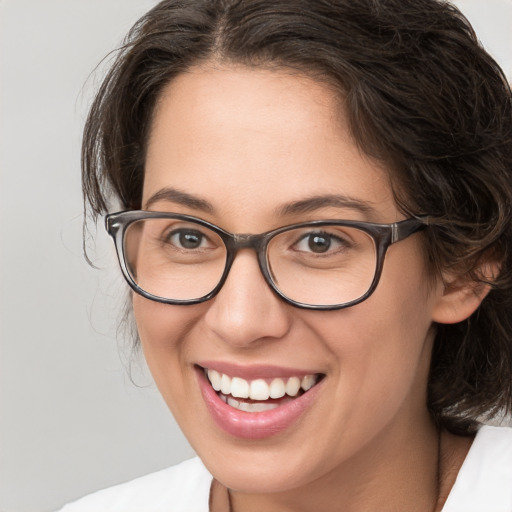 Joyful white adult female with medium  brown hair and brown eyes