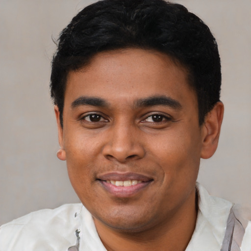 Joyful latino young-adult male with short  black hair and brown eyes