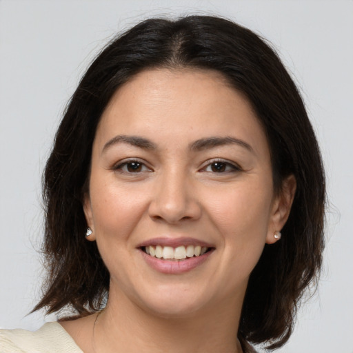 Joyful white young-adult female with medium  brown hair and brown eyes