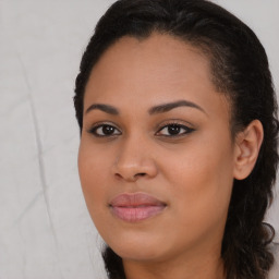 Joyful black young-adult female with long  brown hair and brown eyes