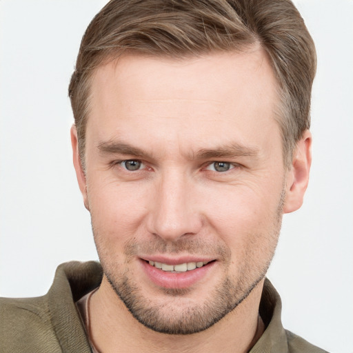 Joyful white young-adult male with short  brown hair and grey eyes