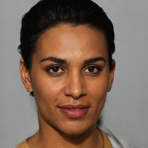 Joyful latino young-adult female with short  black hair and brown eyes
