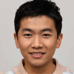 Joyful asian young-adult male with short  black hair and brown eyes