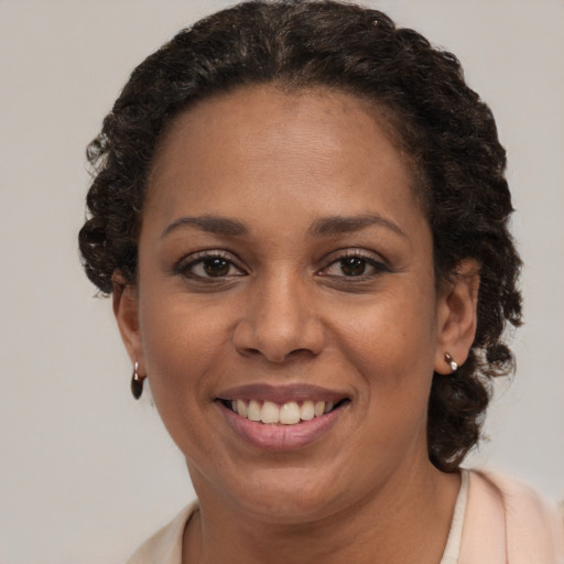 Joyful black adult female with short  brown hair and brown eyes