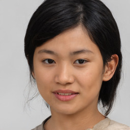 Joyful asian young-adult female with medium  black hair and brown eyes