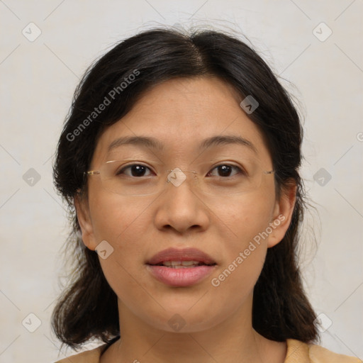 Joyful asian adult female with medium  brown hair and brown eyes