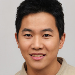 Joyful asian young-adult male with short  brown hair and brown eyes