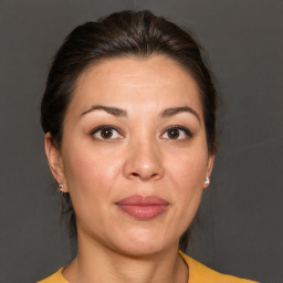 Joyful white adult female with medium  brown hair and brown eyes