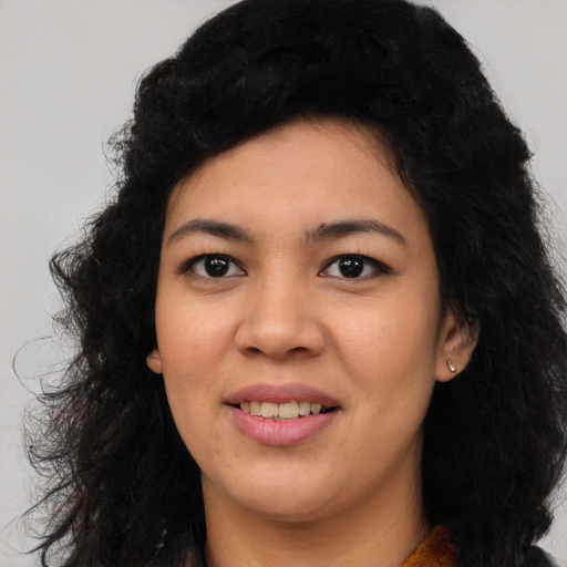 Joyful latino young-adult female with long  black hair and brown eyes