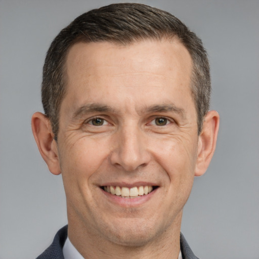 Joyful white adult male with short  brown hair and brown eyes