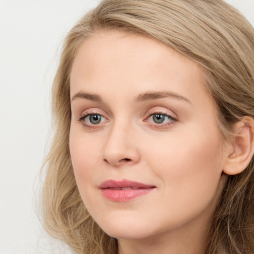 Joyful white young-adult female with long  brown hair and blue eyes