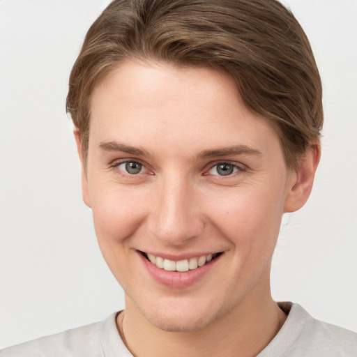 Joyful white young-adult female with short  brown hair and grey eyes