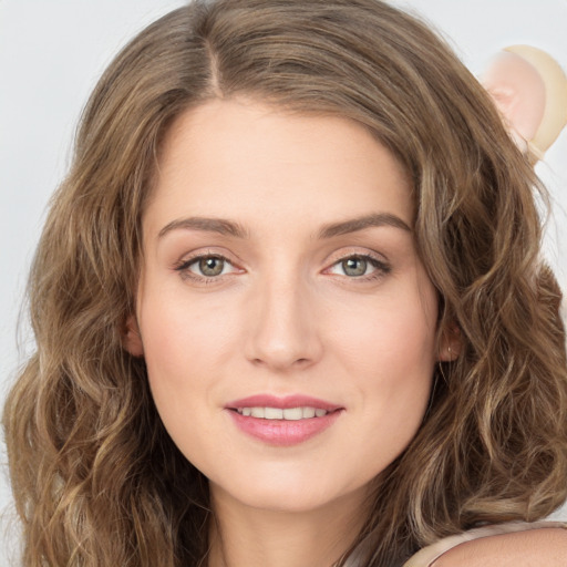 Joyful white young-adult female with long  brown hair and green eyes