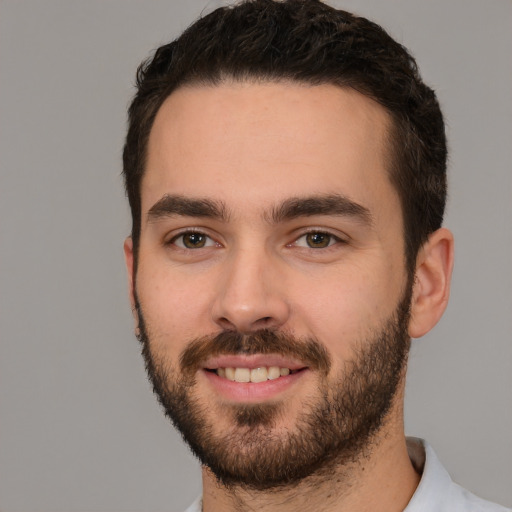 Joyful white young-adult male with short  black hair and brown eyes