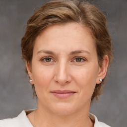 Joyful white adult female with medium  brown hair and brown eyes