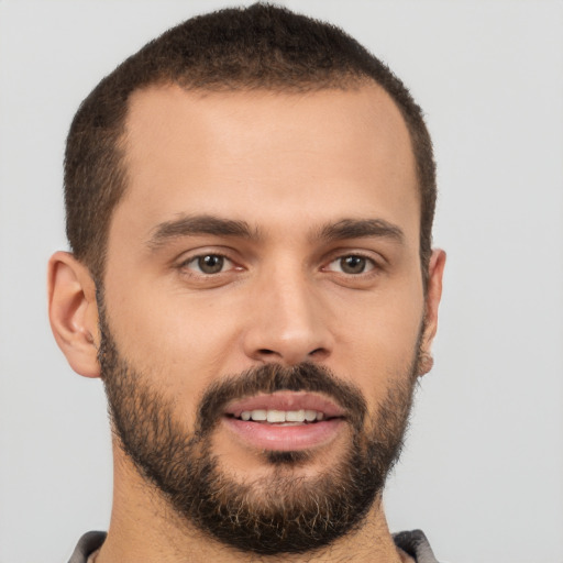 Joyful white young-adult male with short  brown hair and brown eyes